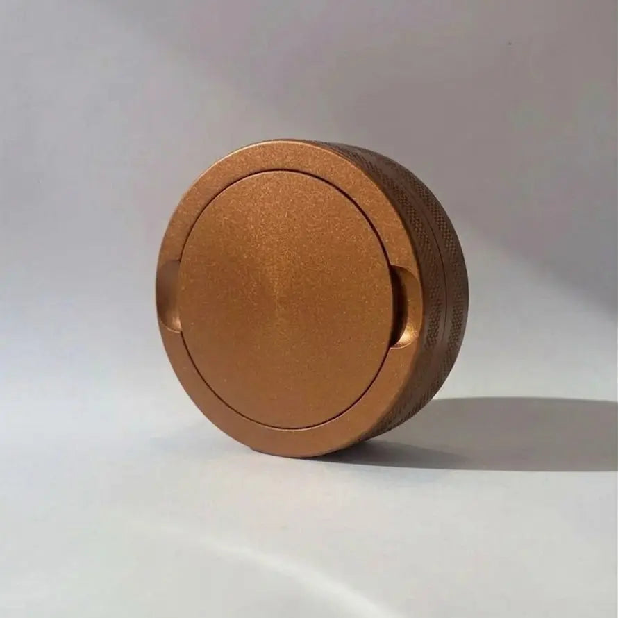 Pouchy Slim in bronze — slim aluminium snus pot with custom engraved finish
