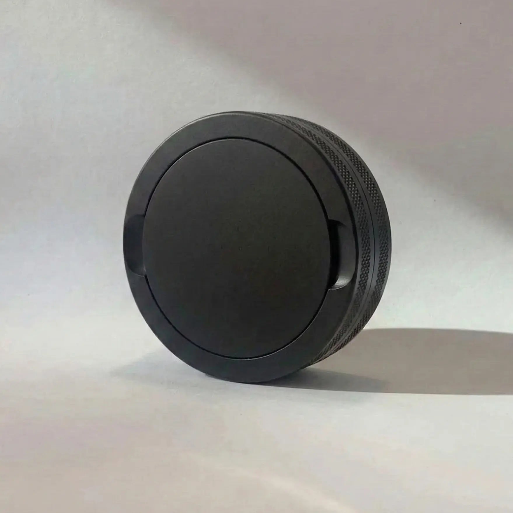 Pouchy Slim in black — compact laser-engraved metal snus pot for nicotine pouches