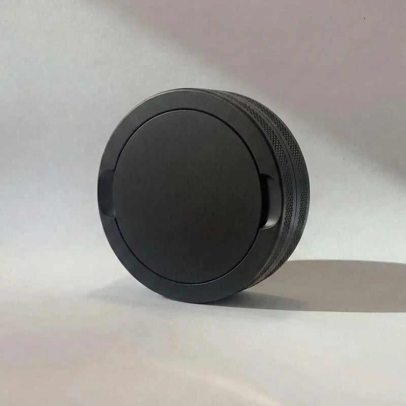 Pouchy Slim in black — compact laser-engraved metal snus pot for nicotine pouches